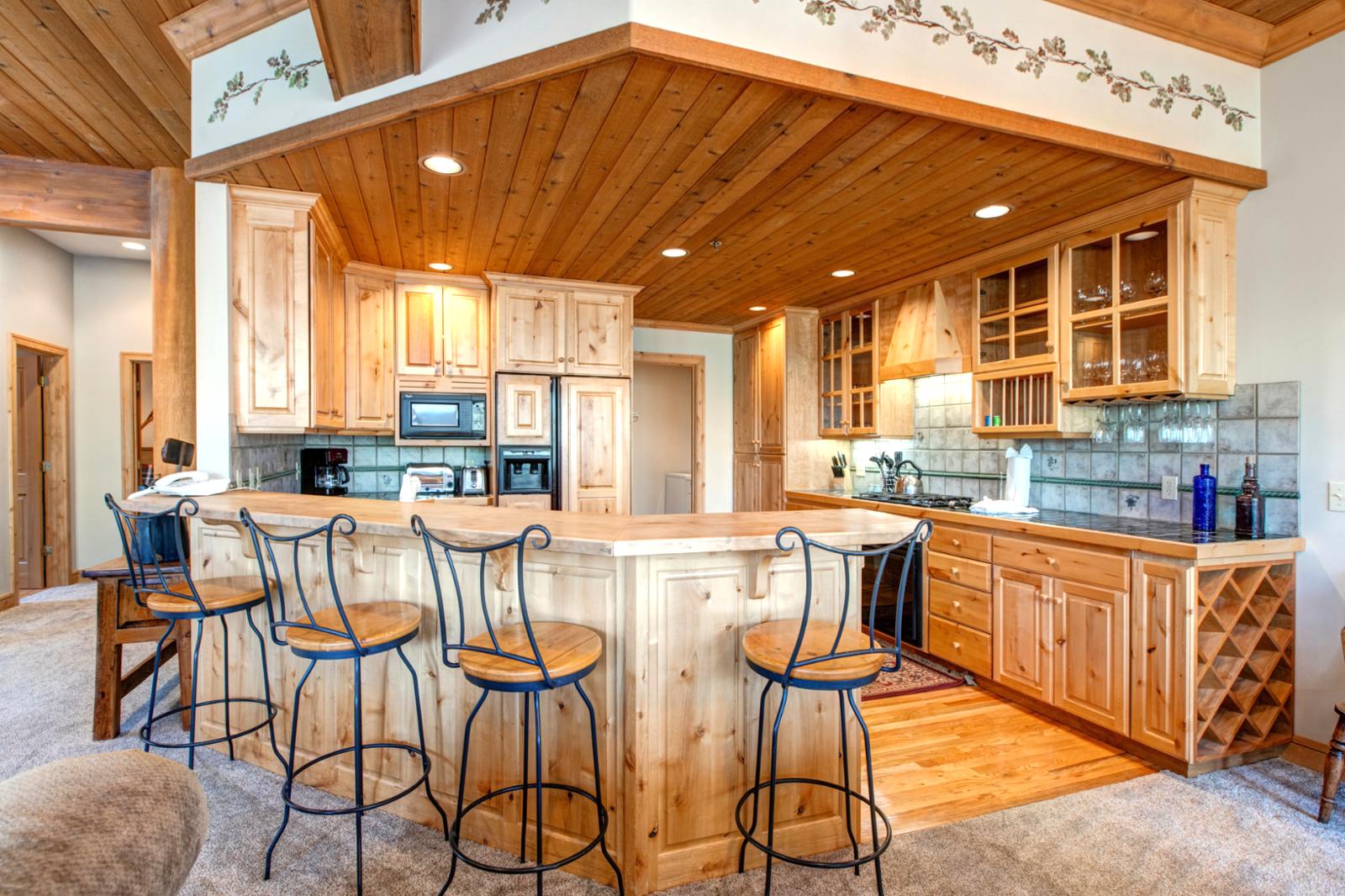 The kitchen island with seating invites casual dining or snacks between outdoor adventures, all in an open and social layout.