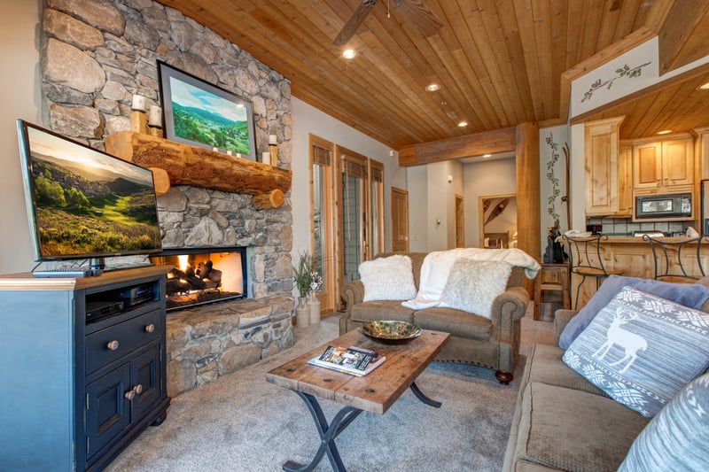 A cozy second living area provides extra lounge space, featuring a sofa sleeper, Smart TV, and access to the deck. Ideal for families or larger groups.