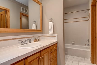 A fourth full bath ensures privacy and convenience for guests, with a granite counter, shower/tub combo, and quality amenities.