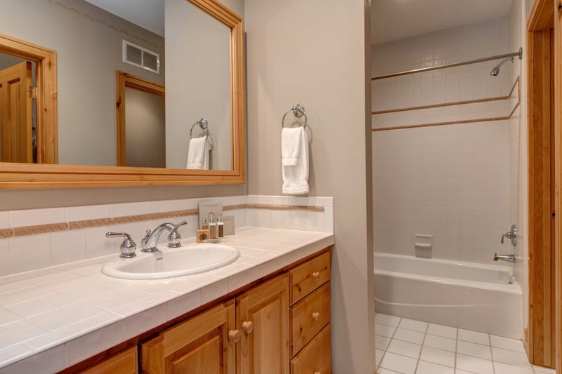 A fourth full bath ensures privacy and convenience for guests, with a granite counter, shower/tub combo, and quality amenities.