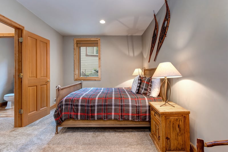 Another view of the bunk room shows cozy lighting and a playful, lodge-inspired design perfect for younger guests.