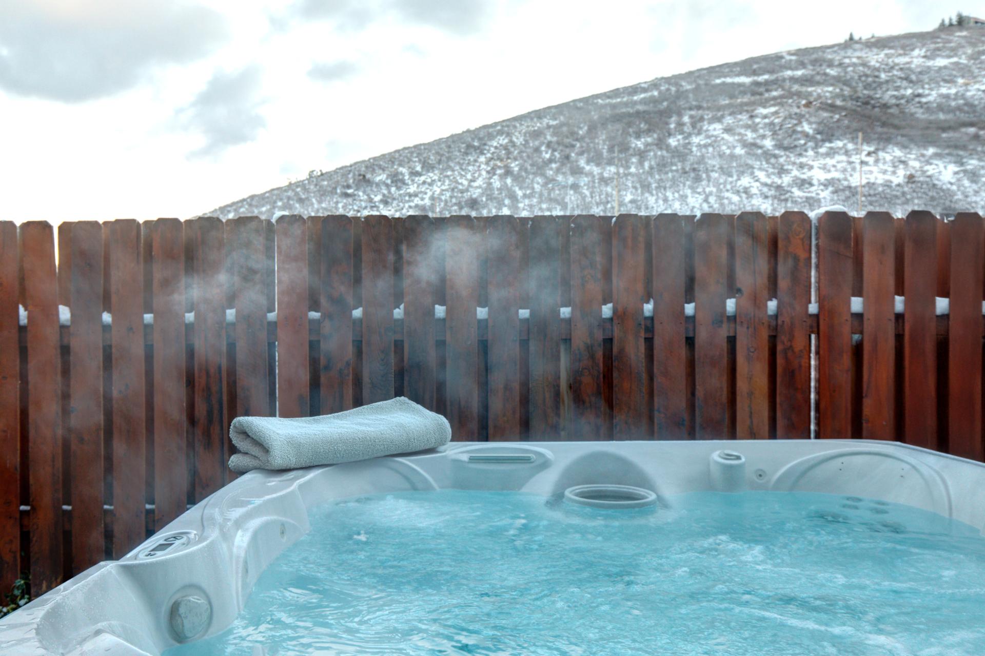Soak under the stars or après-ski in your private fenced-in hot tub with hillside views.