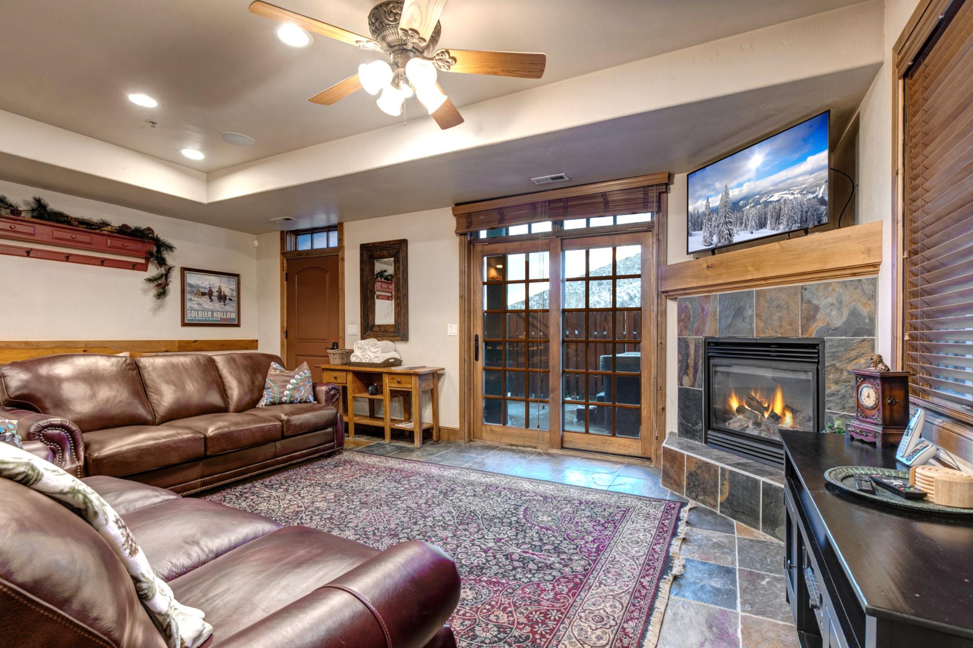 Settle in by the fireplace after a day outdoors in this warm, inviting space.