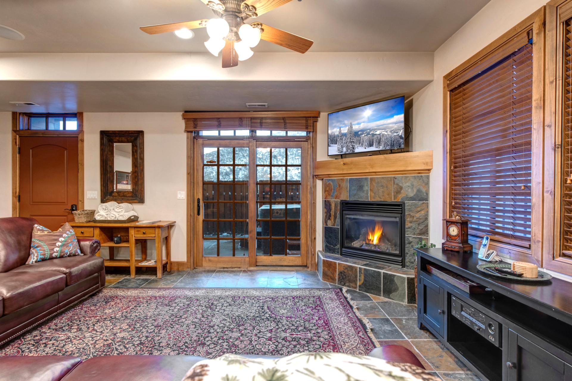 Gather in the cozy main living area with large sectional seating, Smart TV, and mountain lodge finishes.