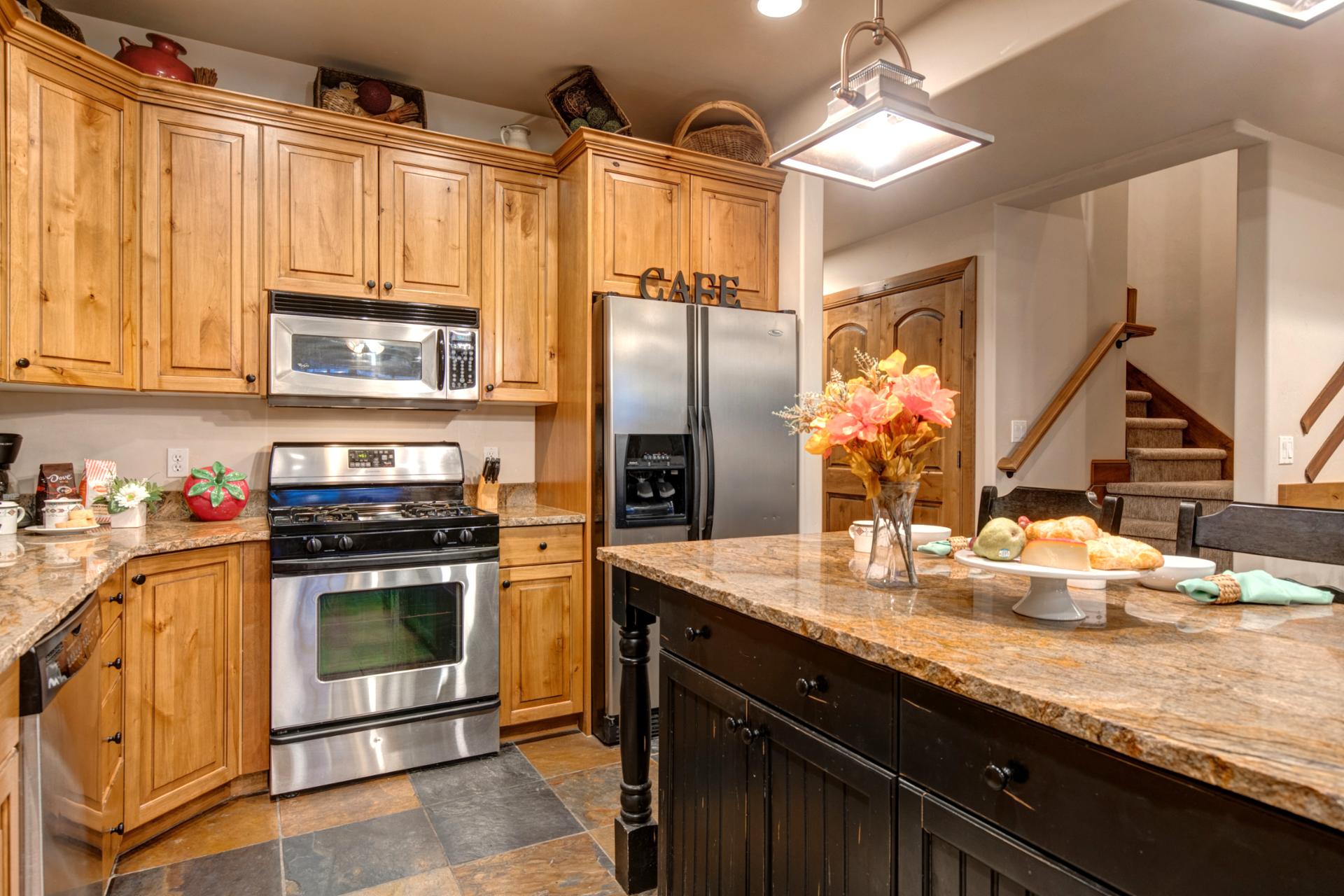 Spacious layout features a center island, pendant lighting, and access to the dining area.