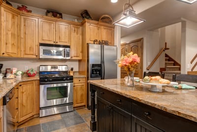 Spacious layout features a center island, pendant lighting, and access to the dining area. PPS-1416