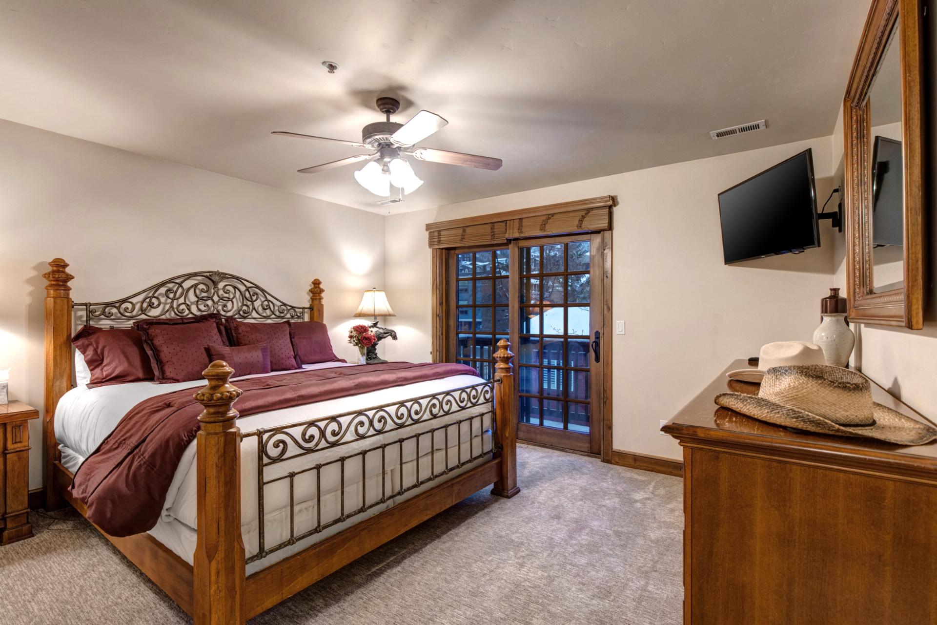 Sleep soundly in the King bed with mountain views, ceiling fan, and private balcony access.