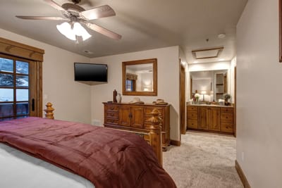 King suite includes a large dresser, ceiling fan, and access to a luxurious en suite bath. PPS-1416