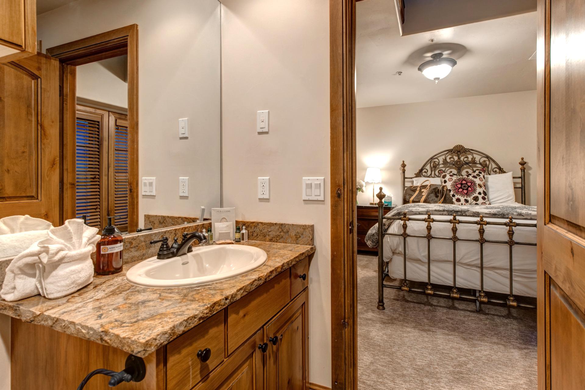 Rustic granite vanity and wrought full jack n jill bathroom for the two queen bedrooms