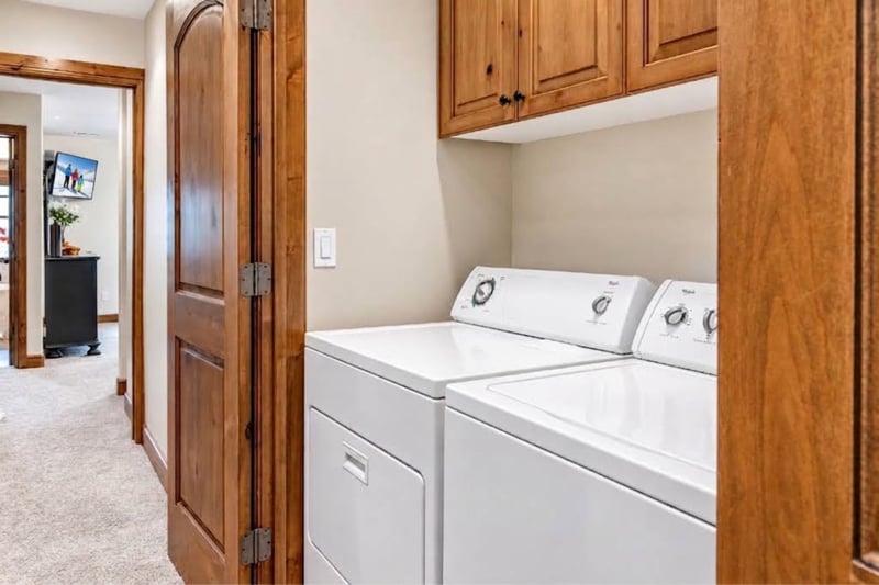 Laundry area with washer, dryer, and upper cabinetry for easy storage and convenience. PPS-1416
