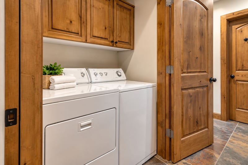 Full laundry room with washer, dryer, and ample storage to keep gear organized.