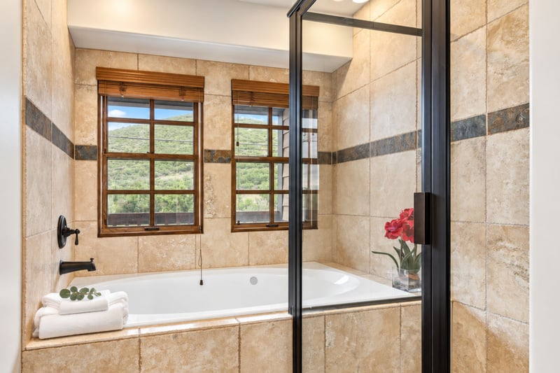Indulge in a soak after a day outdoors in your spa-style bath with glass walk-in shower and deep tub.