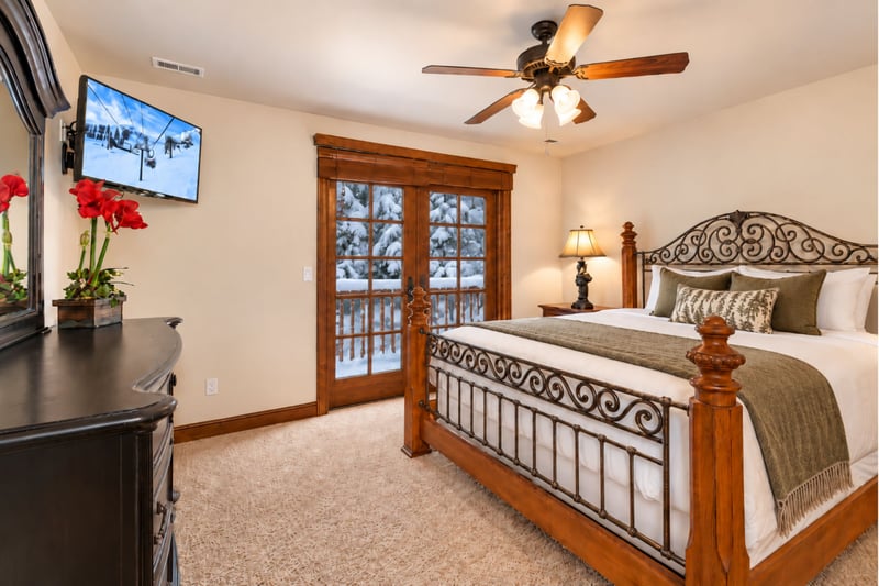 Rest easy in your upper-level primary bedroom with a King bed, Smart TV, and private balcony access.