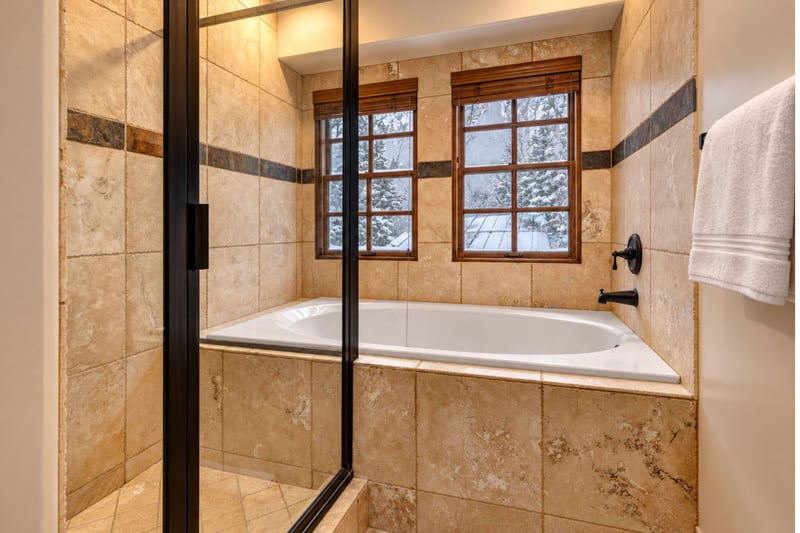 Indulge in a soak after a day outdoors in your spa-style bath with glass walk-in shower and deep tub.