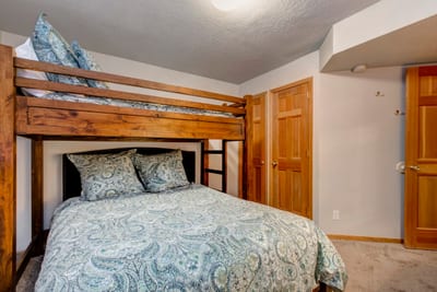 Another angle of Guest Bedroom 4 showing rustic charm and forest views.