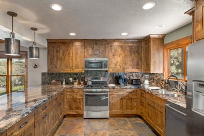 Spacious kitchen offers double ovens, generous prep space, and a central layout for group meals.