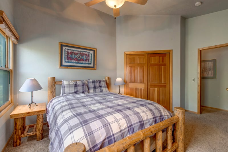 Another look at Guest Bedroom 1 with soft lighting and lodge-style bedding.
