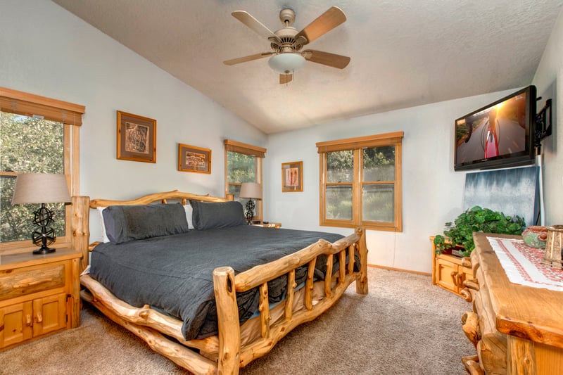 The primary bedroom includes a King bed, ceiling fan, and ensuite bath for total comfort and privacy.
