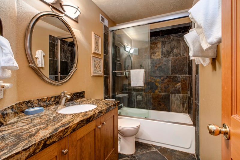 Guest Bath 3 has a tub/shower combo and serves Bedrooms 3 and 4 on the lower level.
