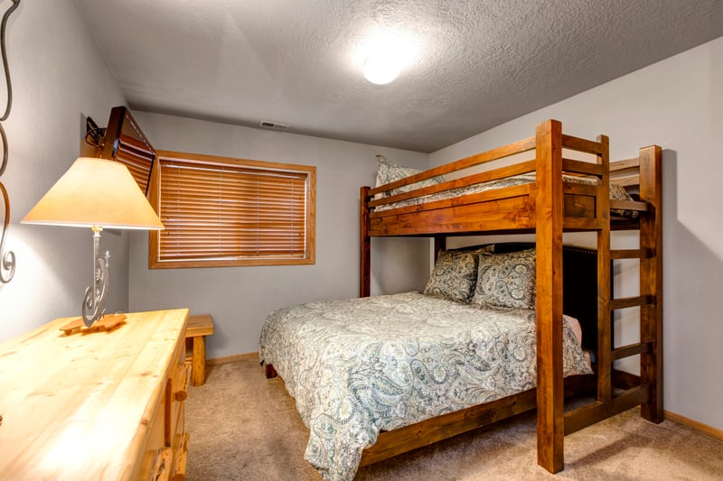 Guest Bedroom 4 includes a Twin-over-Queen bunk and cozy wood tones for a restful stay.
