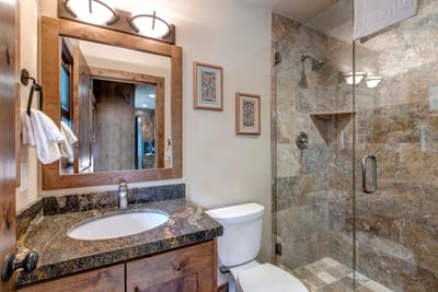 Guest Bath 4 near the kitchen includes a walk-in shower and sleek fixtures for easy access.