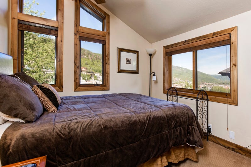 The 2nd bedroom includes a Queen bed, large windows, and calming natural light.