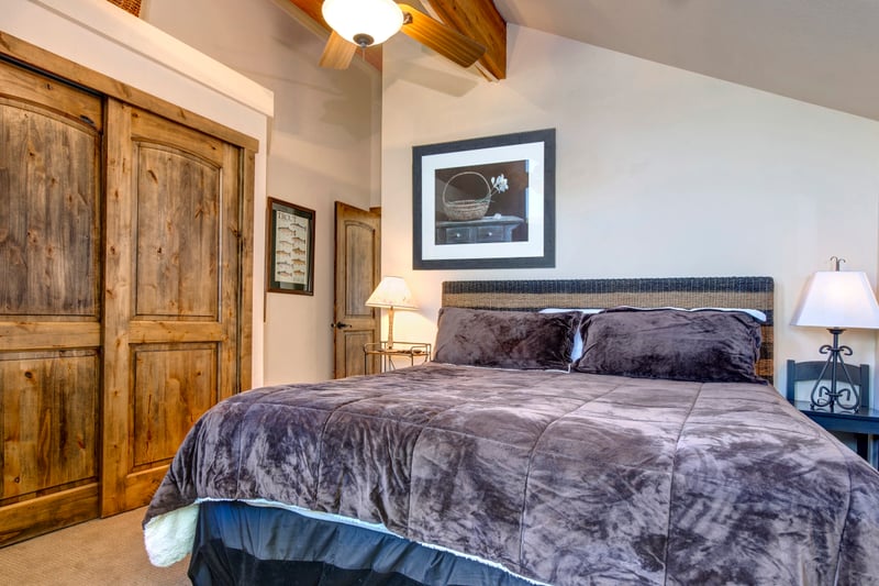 Sleep soundly in your King bedroom with natural light, warm wood tones, and ensuite bath access.