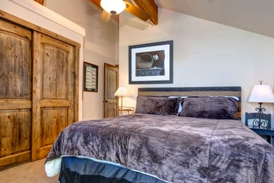 Sleep soundly in your King bedroom with natural light, warm wood tones, and ensuite bath access.