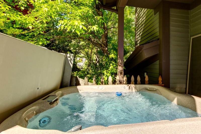 Your outdoor hot tub is tucked in a private corner with a peaceful atmosphere