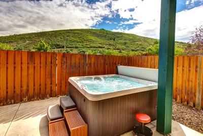 Hot tub offers privacy and comfort with wooden fencing and outdoor lighting, year round. PPS-1416