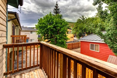 Wood deck balcony right off of bedroom suite offers space to sip morning coffee or enjoy evening views. PPS-1416