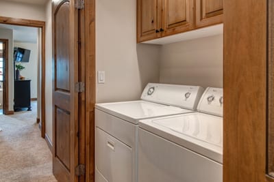Laundry area with washer, dryer, and upper cabinetry for easy storage and convenience. PPS-1416