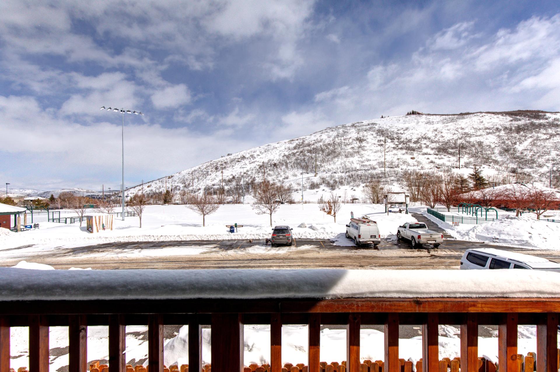 Snow-covered landscape with hill views and bright skies, just steps from the home.