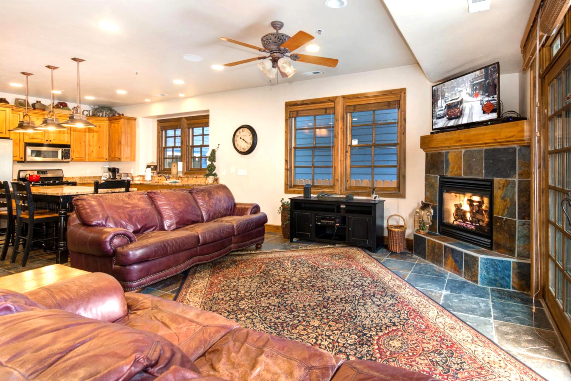Gather in the main living area with plush seating, a gas fireplace, and Smart TV for movie nights after a day on the slopes.
