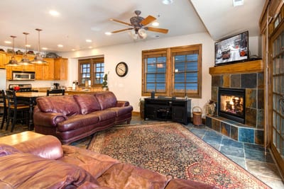 Gather in the main living area with plush seating, a gas fireplace, and Smart TV for movie nights after a day on the slopes.