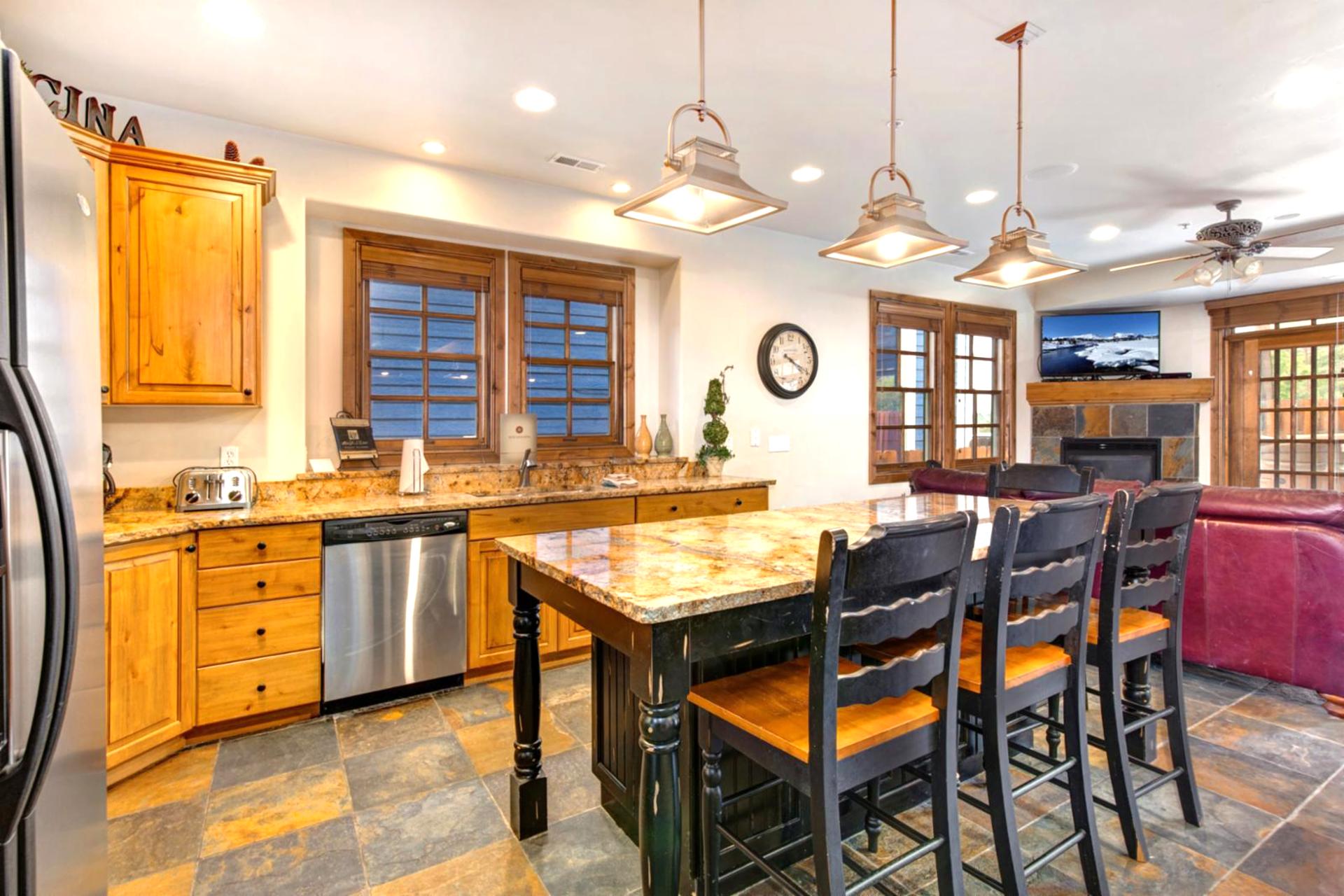The kitchen offers stainless appliances, granite counters, and pendant lighting for prepping meals with ease.
