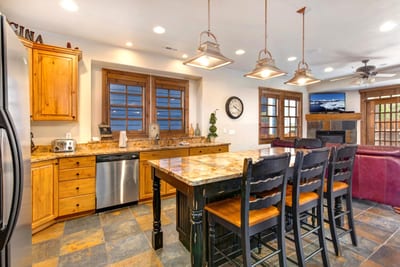 The kitchen offers stainless appliances, granite counters, and pendant lighting for prepping meals with ease.