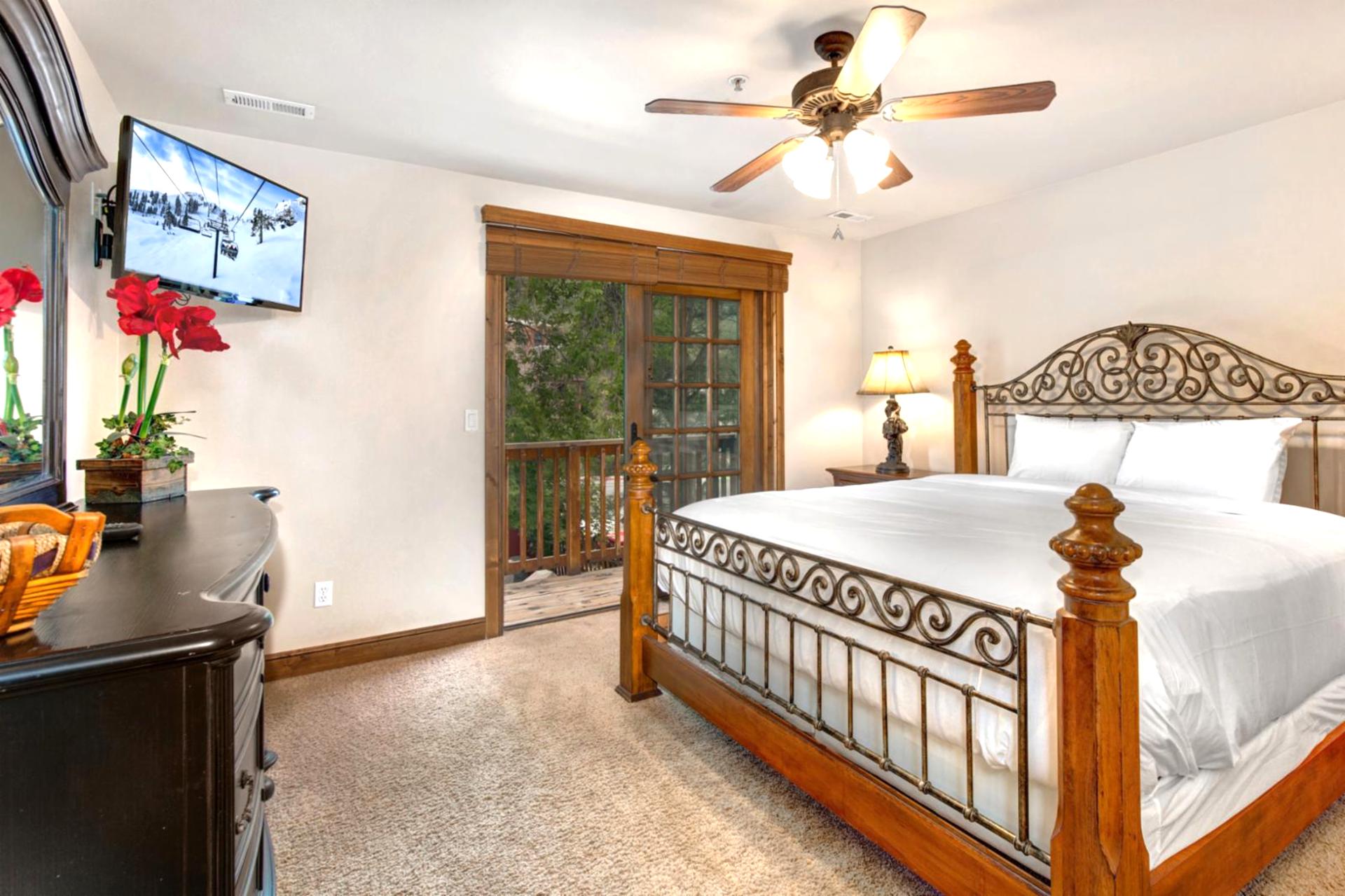 Rest easy in your upper-level primary bedroom with a King bed, Smart TV, and private balcony access.
