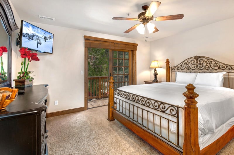Rest easy in your upper-level primary bedroom with a King bed, Smart TV, and private balcony access.