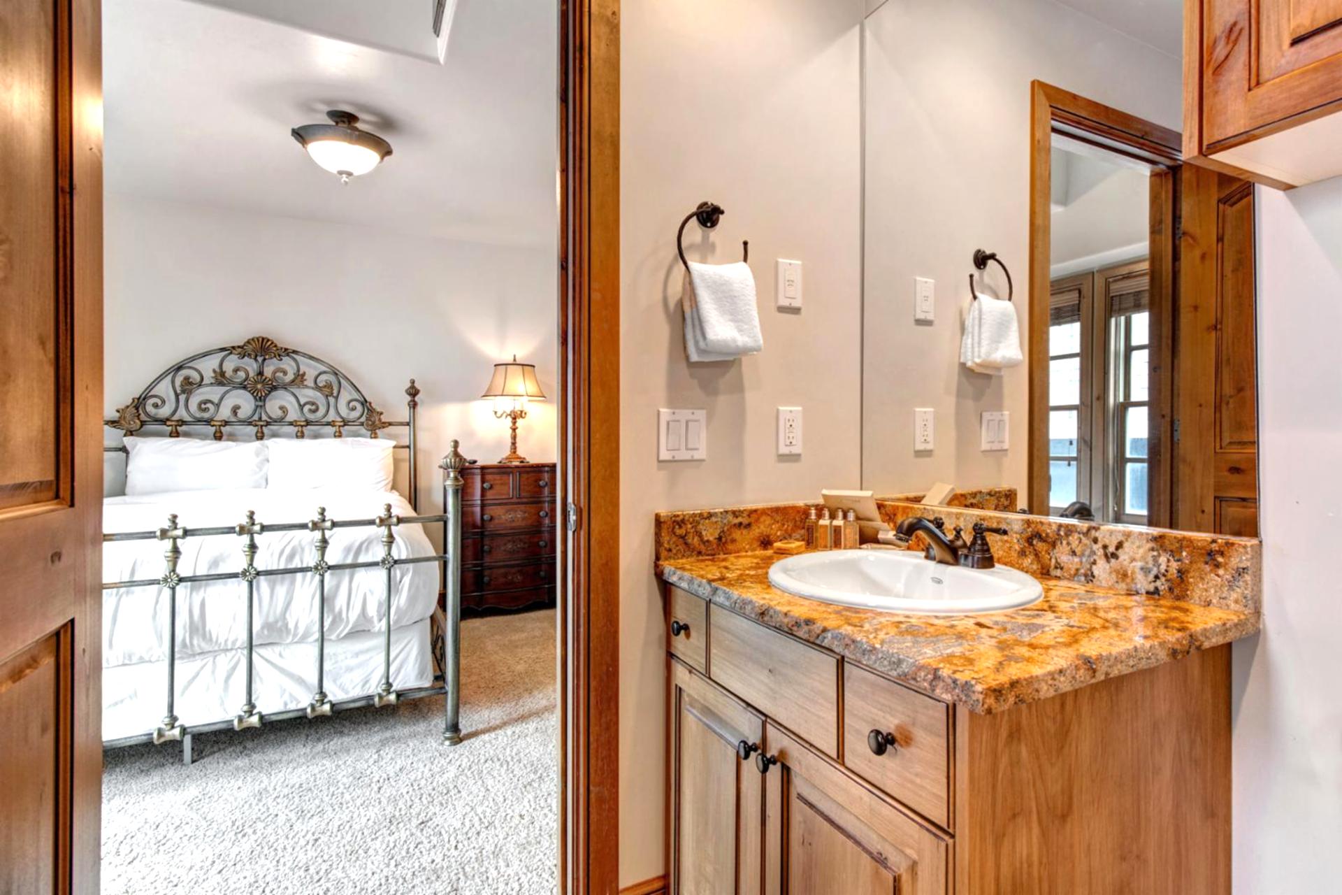 Guest Bathroom 1 includes granite counters, shower-tub combo, and quality finishes stocked with L’Occitane amenities.
