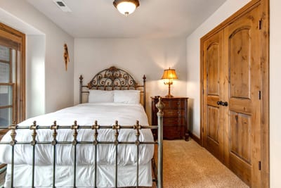 A second view of Guest Bedroom 2 shows its open layout and access to a full bath.