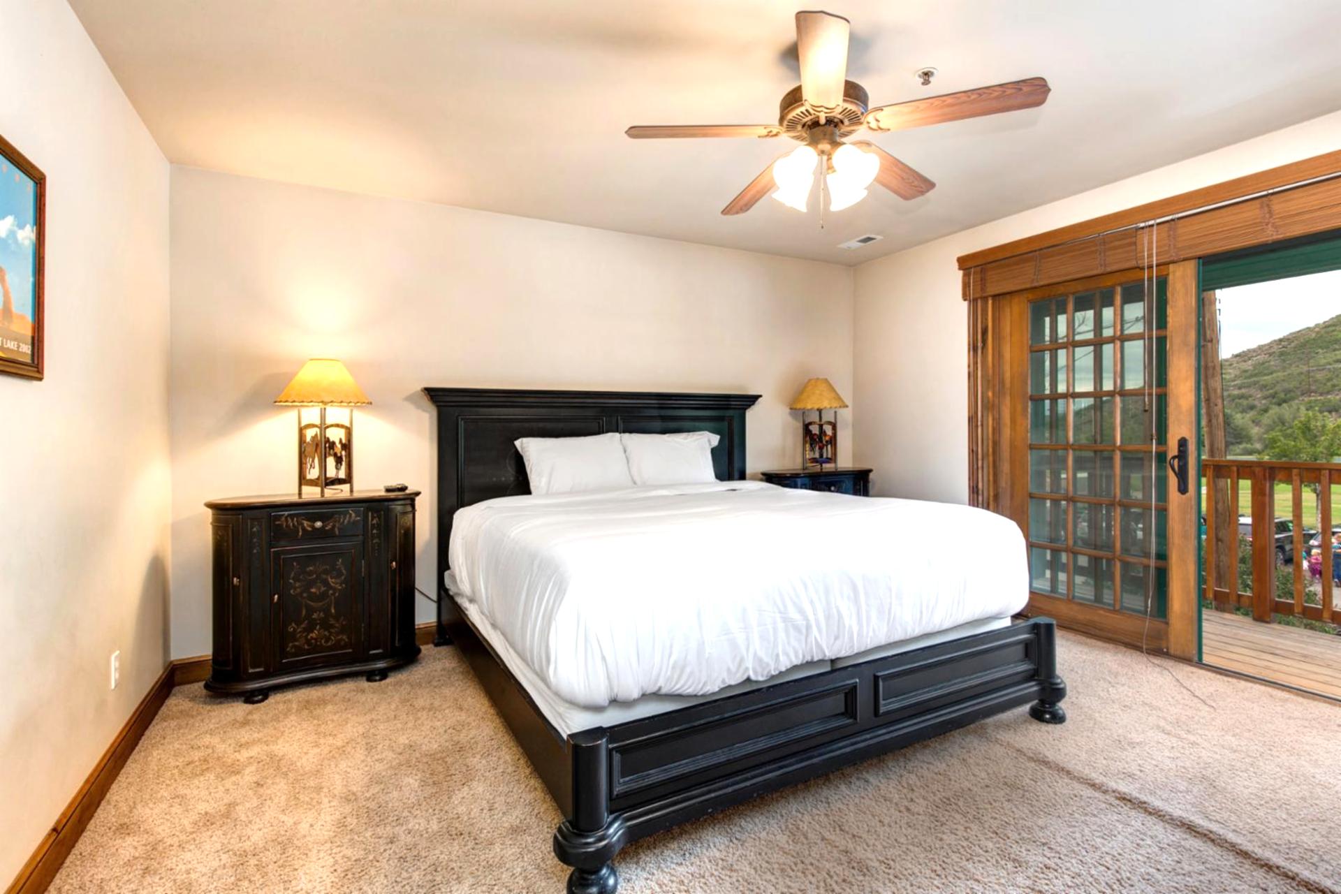 Guest Bedroom 3 has a Queen bed, Smart TV, and French doors opening to a balcony with views.
