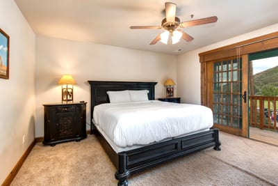 Guest Bedroom 3 has a Queen bed, Smart TV, and French doors opening to a balcony with views.