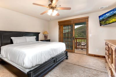 Another view of Guest Bedroom 3 showing ceiling fan, closet, and carpeted floors for comfort.