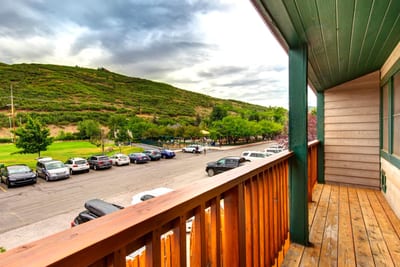 Step out from the bedrooms to this balcony with mountain greenery and neighborhood views.