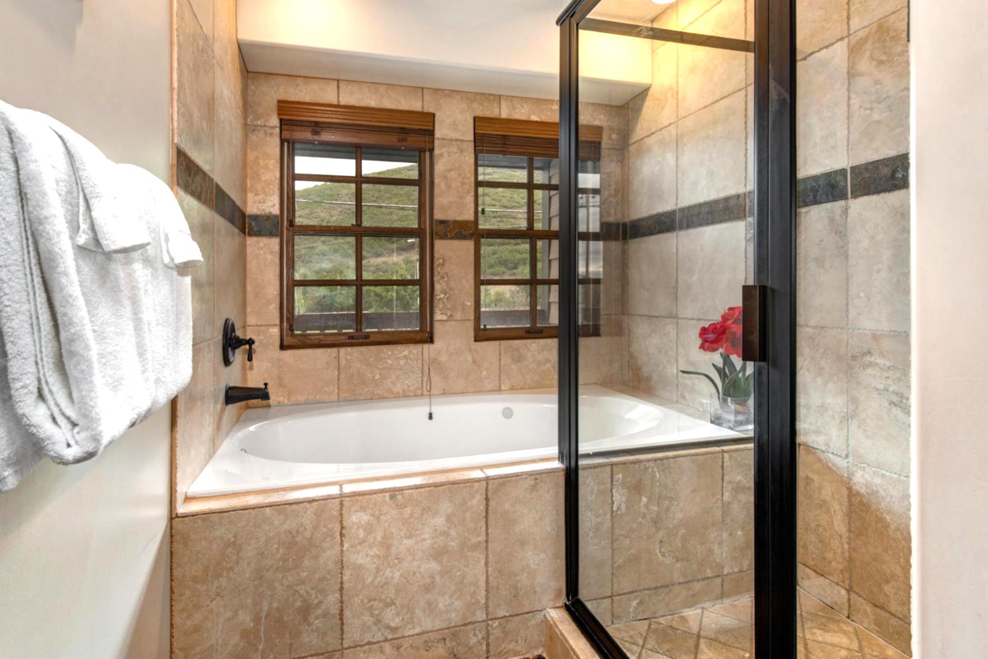 Indulge in a soak after a day outdoors in your spa-style bath with glass walk-in shower and deep tub.
