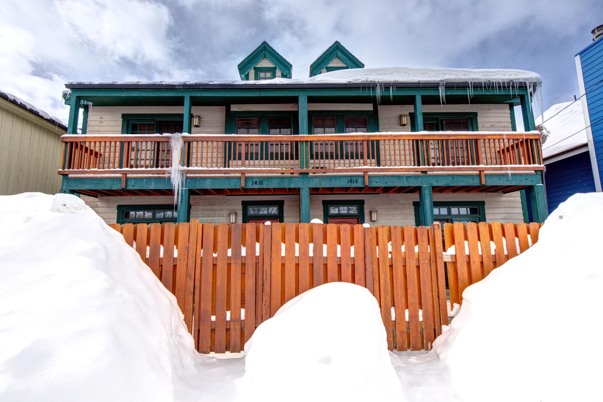 A snow-covered view of your townhome entry, just steps from adventure with two private balconies above.
