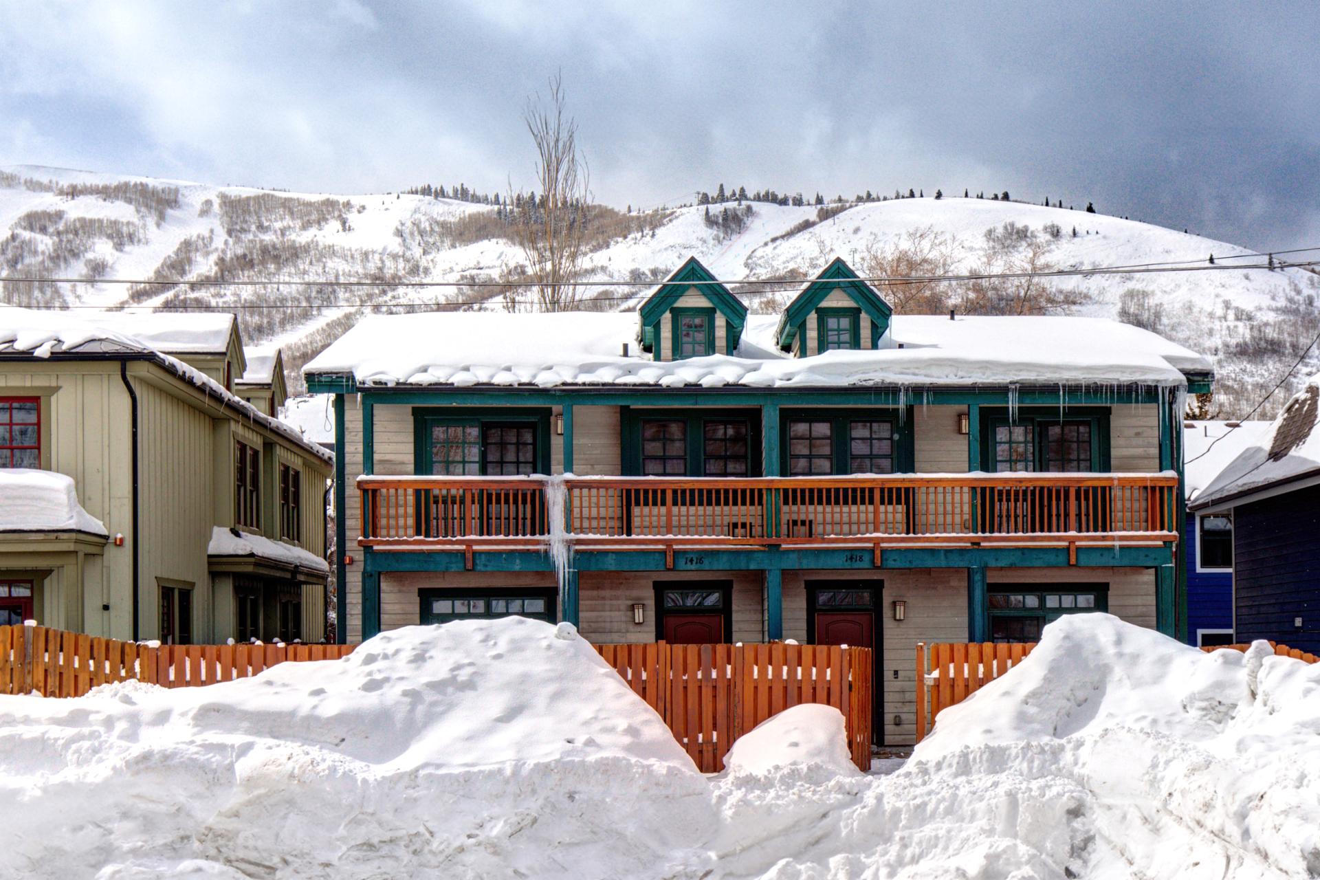 Exterior winter view shows the two balconies and garage of your townhome.
