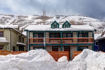 Exterior winter view shows the two balconies and garage of your townhome.