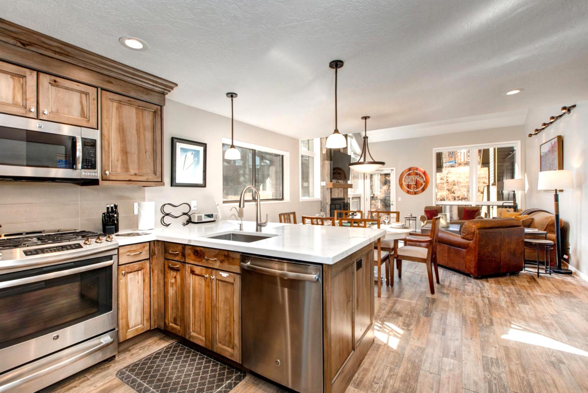This alternate kitchen angle shows ample prep space, cabinetry, and a view to the adjacent dining area.